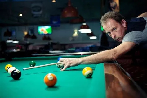 Why do pool players tap the ball?