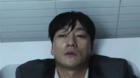 What is sang-woo doing in the bathroom?